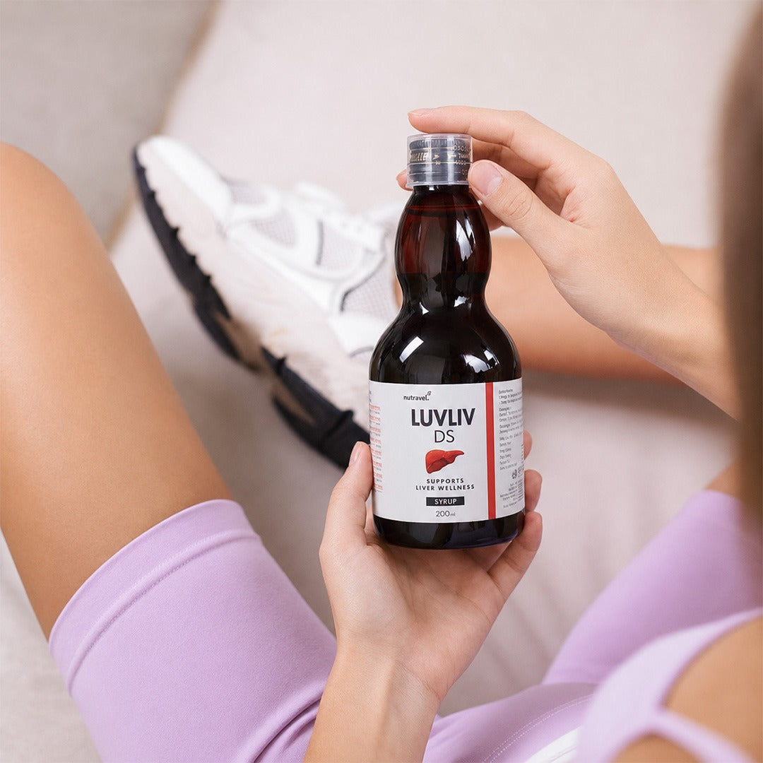 Woman holding a bottle of Luvliv DS liver syrup